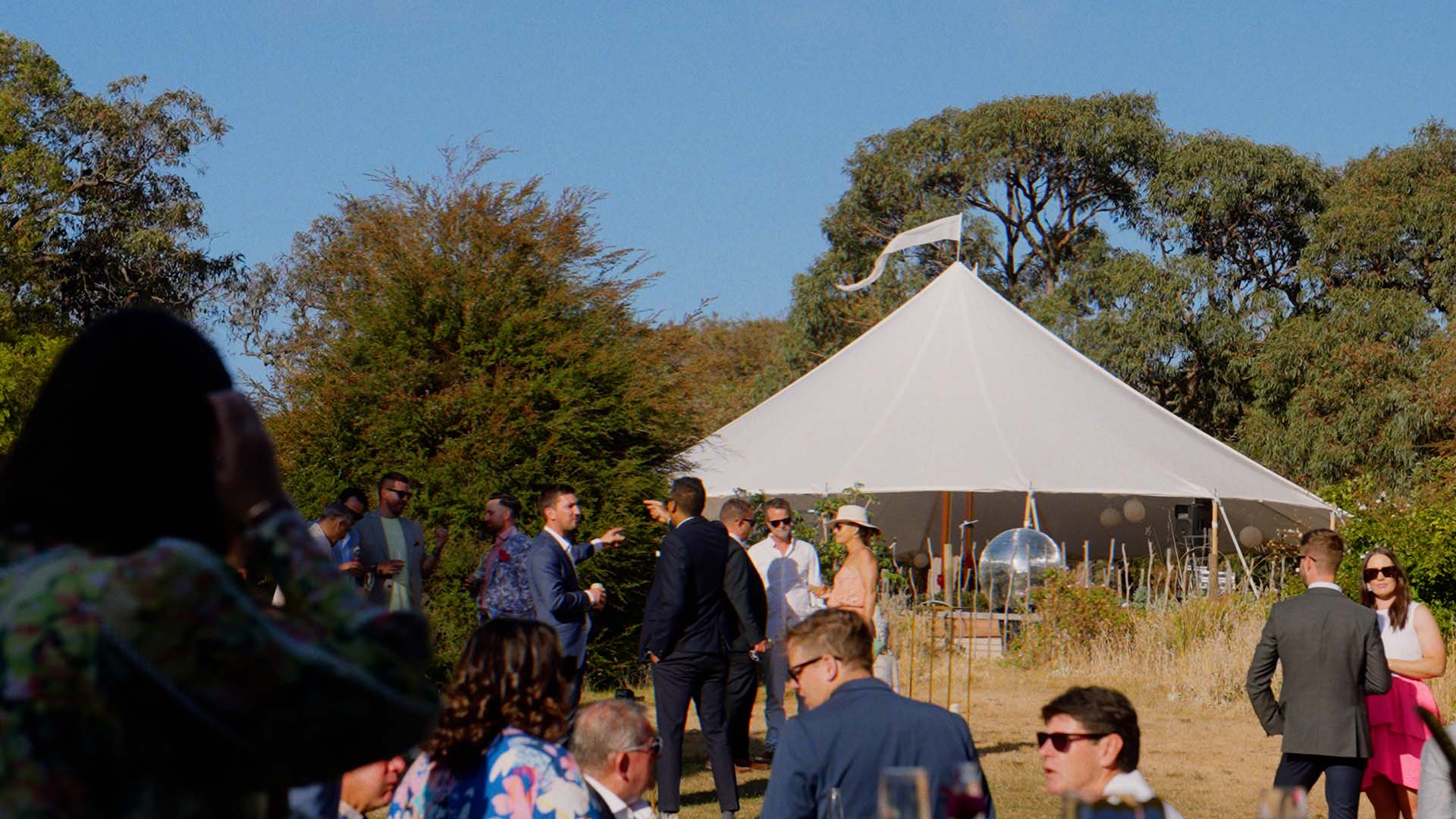 Hanging lights and disco ball over the dance floor at Cody and Sam's Mornington Peninsula wedding