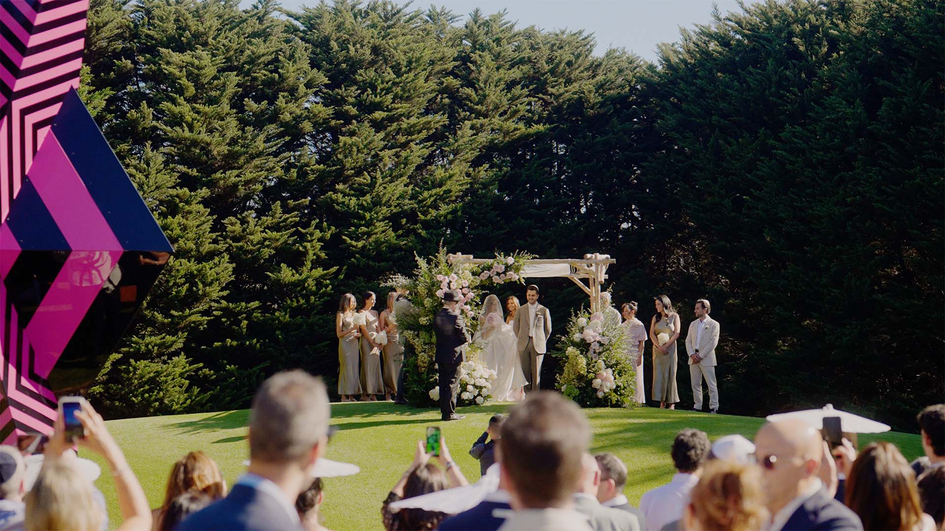 wedding guests capturing moments on their phones