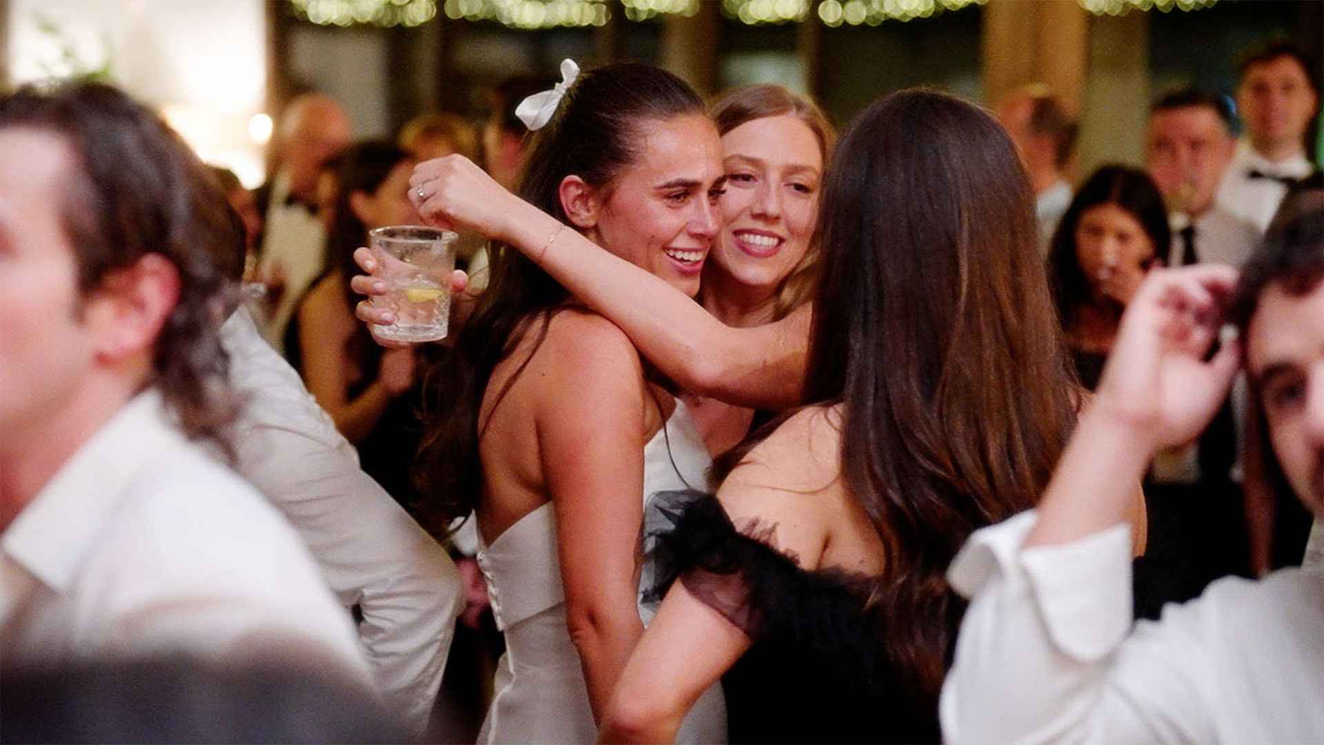 Bride hugging guests on the dance floor